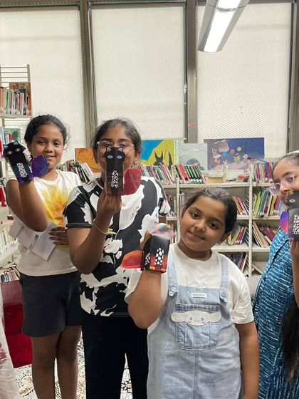 Children proudly show off the puppets they created in a workshop. Our summer camp is packed with creative, hands-on activities that make learning French fun.
