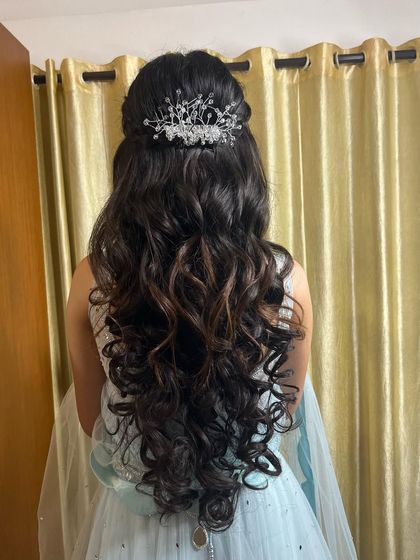 A beautiful half-up style with voluminous curls and a stunning crystal crown, perfect for a reception or engagement gown.