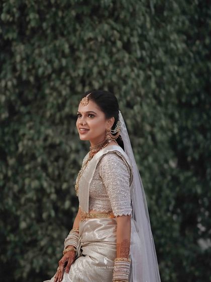 A stunning portrait of a bride in a silver saree, looking like she stepped out of a movie.