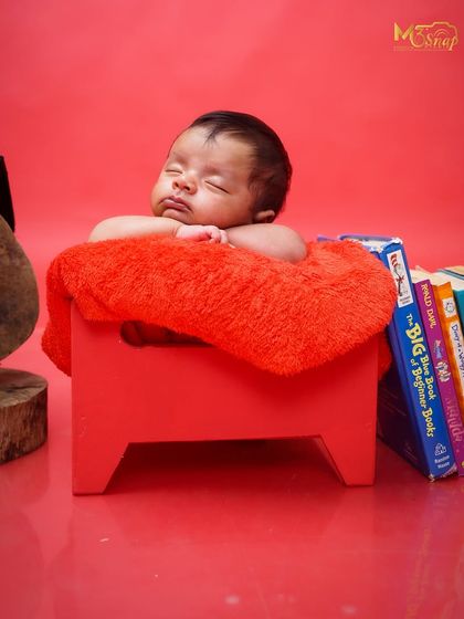 Another variation of the little scholar theme, with books stacked beside the sleeping baby. It tells a sweet story of big dreams for a little person.
