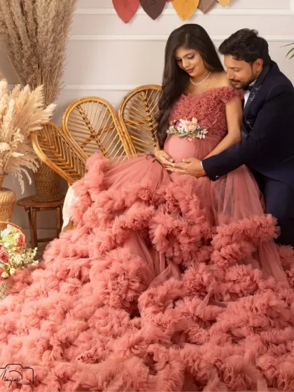 A tender moment between the couple in the boho corner. The way he looks at her and the baby bump is filled with so much love and admiration.