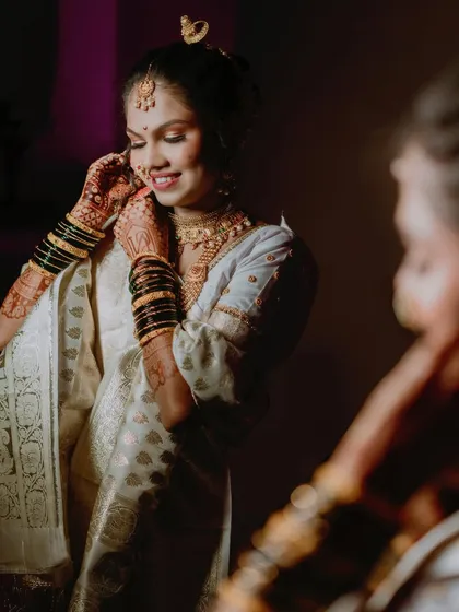 Another beautiful getting-ready moment. The bride's smile as she puts on her jewelry shows her excitement for the day ahead.
