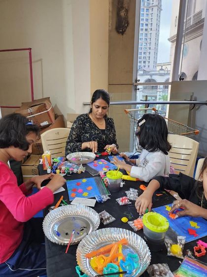 A table full of young artists, each focused on their own canvas and clay project. It is amazing to see so many different ideas come to life in one room.