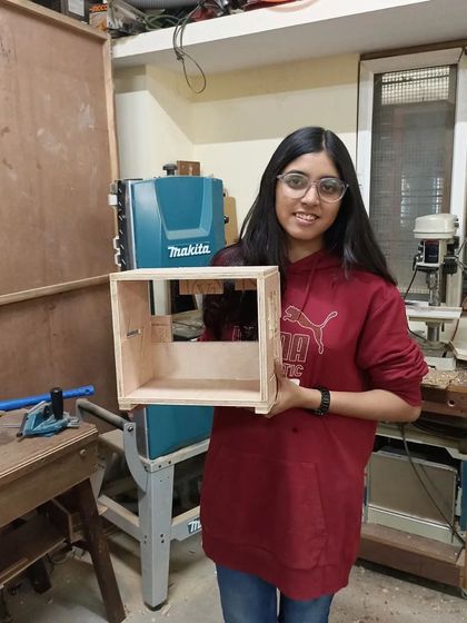 A simple, modern box shelf with an internal compartment, built by an interior design student. It's a versatile piece that can be used in many ways.