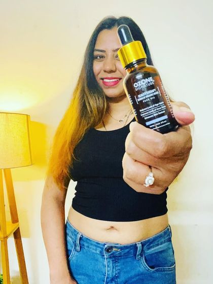 A close-up shot where I'm presenting the Ozone Signature Haridradya Taila, ready to incorporate it into my nightly skincare routine for its blemish-fading properties.