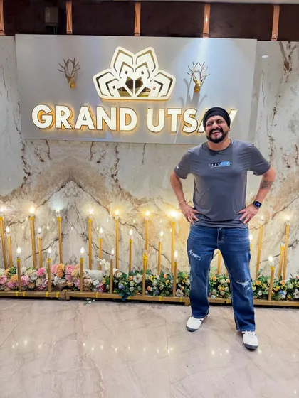 Posing confidently at the Grand Utsav. Ready to make this birthday party a memorable one for the Bal family.