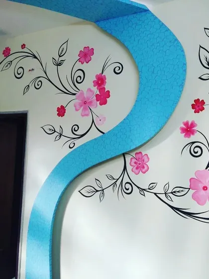 A beautiful hand-painted floral vine mural flows across the wall and onto a textured archway. This project combines our artistic mural services with textured painting for a fully integrated design.