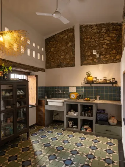 This is the kitchen in my own studio, a space I brought back to life from an 80-year-old forgotten structure. I kept the soul of the building intact, exposing the original stone and brick walls. The space is a testament to my love for heritage restoration, blending rustic mitti finishes with functional, soulful design.