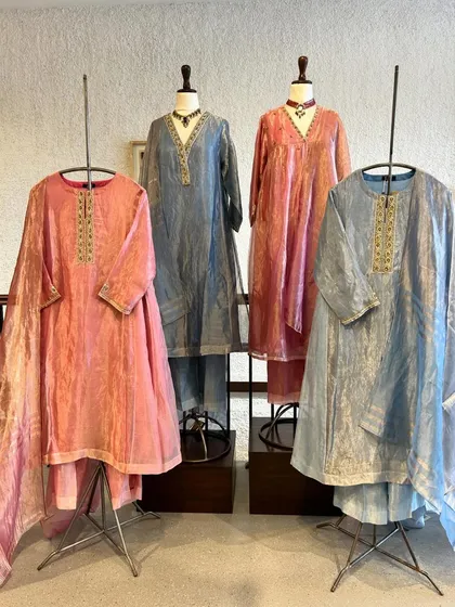Elegance in every thread. This display features beautiful crushed silk kurta sets in soft shades of pink and blue, perfect for a sophisticated daytime event.