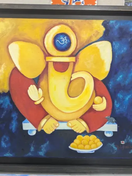 The completed Ganesha painting in its frame. The modern interpretation and vibrant colors make this a truly special piece of art.