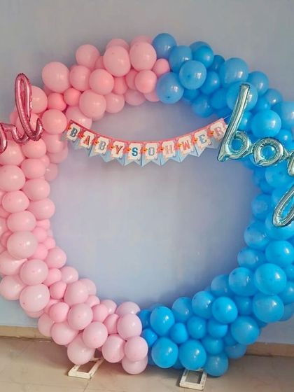 A 'boy or girl' themed baby shower balloon ring. The half-pink, half-blue design is a popular choice for gender reveal parties.
