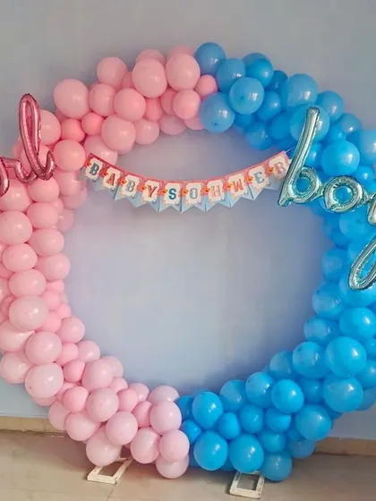 A 'boy or girl' themed baby shower balloon ring. The half-pink, half-blue design is a popular choice for gender reveal parties.
