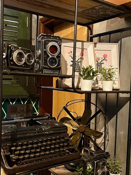 I love adding vintage touches to my decor, like these old cameras and a typewriter, to create a unique and interesting ambiance.
