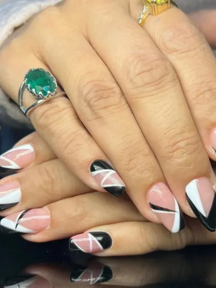 A striking geometric design with black, white, and nude color-blocking on long, square-shaped nails for a modern and edgy look.