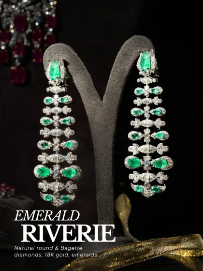 The Emerald Riviere earrings, featuring natural round and baguette diamonds with emeralds in 18k gold. A statement piece that tells a story in gold and stone.