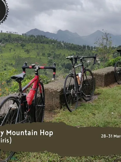 Our 'Misty Mountain Hop' tour in the Nilgiris offers stunning views of mist-covered peaks. This image shows bikes resting at a viewpoint, ready for the next leg of the adventure.