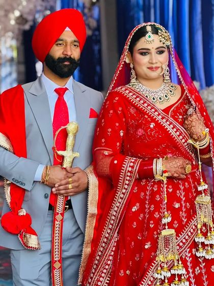 A beautiful portrait of my bride with her groom. Her classic red lehenga and radiant makeup create a timeless look for their special day.