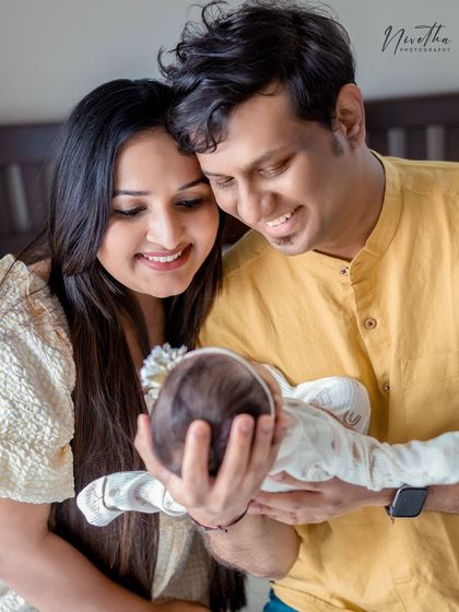 A new family admiring their precious baby. These are the moments that you'll look back on for years to come.