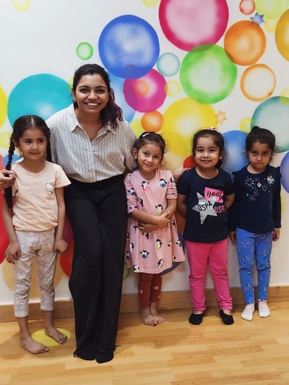 A proud teacher with her students. We celebrate their growth at every step of their dance journey.