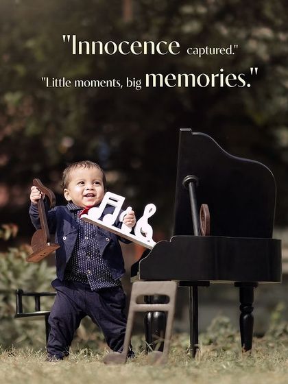 Innocence captured. A little boy stands and plays with musical note props next to his mini piano in the park.