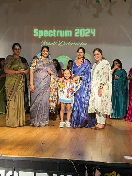 A moment of immense pride. Our student receives her first-place medal and certificate at the 'Spectrum 2024' inter-school competition, standing with our proud teachers.