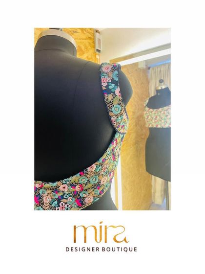 The back design of a custom floral sequin blouse. The deep U-shape and colorful embroidery make it a stunning choice for a sangeet or cocktail event, designed to look beautiful from every angle.