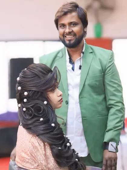 Posing with a model after a class demonstration. This open hairstyle with pearl embellishments is a popular look that I teach in my advanced courses.