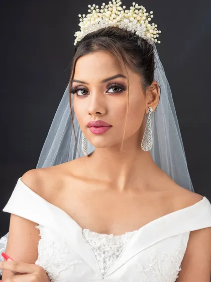 A direct, confident pose from the bride. The makeup is designed to look stunning from every angle, a crucial aspect of professional bridal work.