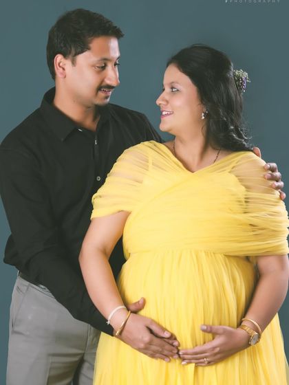 A classic couple's portrait for a maternity shoot. The yellow gown adds a splash of sunshine and happiness to this memorable photo.