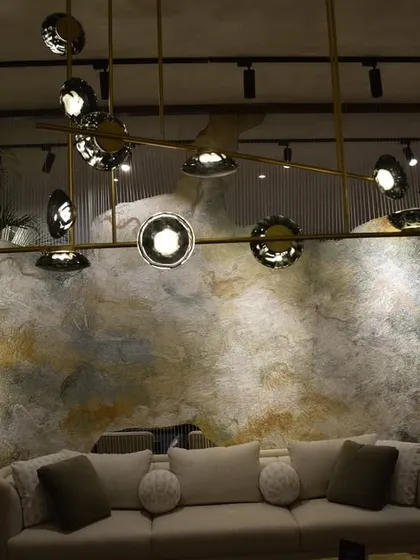Another shot of the India Art Fair VIP lounge, showing the Ross Gardam Ceto chandelier against a textured wall. My goal was to create a space where lighting and art are in constant dialogue.