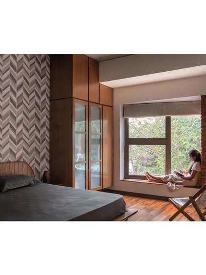In the Nairy Residence, I create intimate moments of connection with the outdoors. This bedroom features a deep bay window seat, a quiet perch that frames the lush greenery outside, transforming a simple window into a personal retreat and filling the space with soft, natural light.