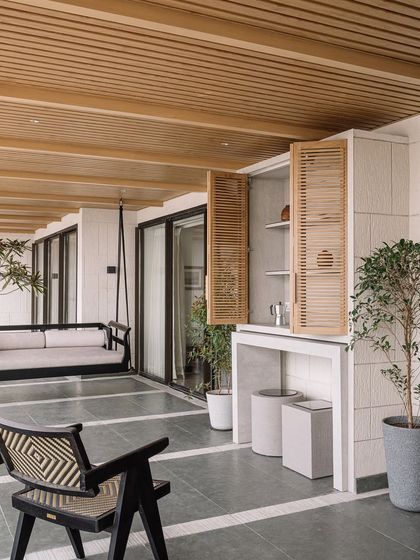 The bar area on the deck is cleverly integrated with louvered shutters. This space is designed for entertaining, offering a place to prepare drinks while enjoying the panoramic city and sea views.