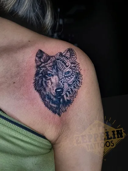 A wolf tattoo where one half is realistic and the other is a geometric mandala pattern. This design represents the duality of a person's nature: part wild instinct, part balanced spirit.