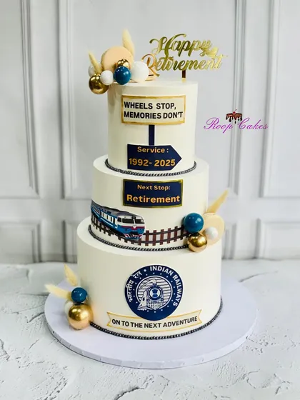 Wheels stop, but memories roll on. This three-tier cake celebrates a remarkable journey and retirement from Indian Railways, complete with a train and logos.