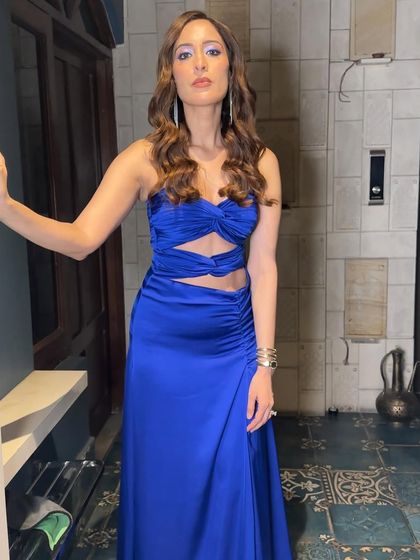 High-octane glamour in electric blue. This look is all about making a statement with a bold, graphic blue eyeliner, balanced with bronzed skin and a neutral lip.