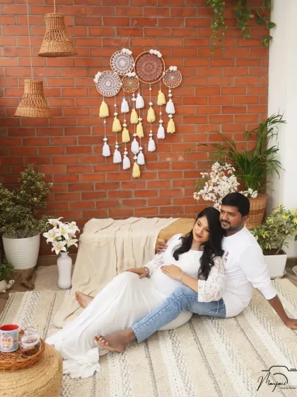 A relaxed and intimate portrait of the couple on the floor of the cozy corner setup. Their bare feet and casual pose give it a very natural feel.