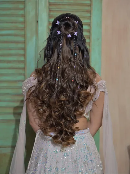 A closer look at the whimsical butterfly hairstyle, showing the delicate braids and scattered clips.