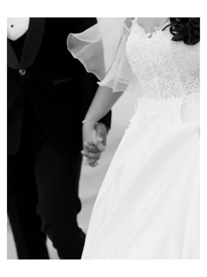 A close-up, black and white detail shot of Jithin and Jennifer holding hands. This simple gesture speaks volumes about their new beginning and the bond they share.