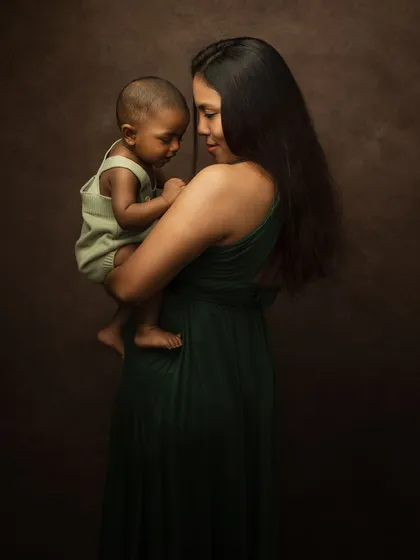 A quiet, loving moment between mother and child. Her gentle gaze and his peaceful expression tell a story of pure, unconditional love.