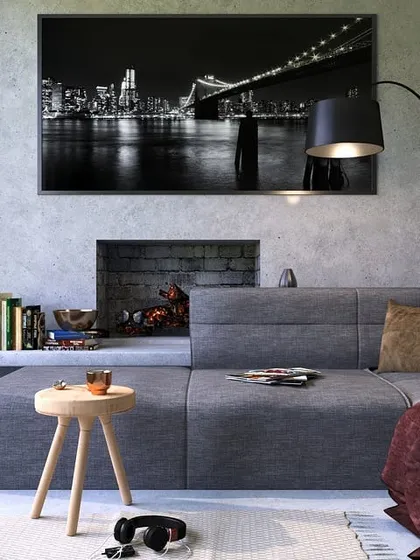 This modern living room showcases a concrete-effect textured paint finish. This industrial-chic style provides a neutral yet impactful backdrop that enhances contemporary furniture and decor.