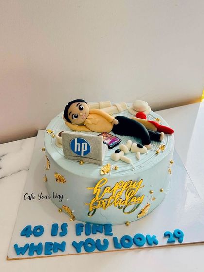 A cake that says "40 is fine when you look 29," featuring the birthday boy's favorite things.