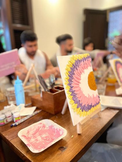 A work-in-progress shot from a couple's texture art workshop. Each partner works on one half of a whole design.