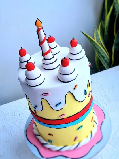 This comic book style cake is a fun and trendy design. I teach the technique of using black fondant outlines to create this 2D cartoon effect, making the cake look like it jumped right out of a drawing.