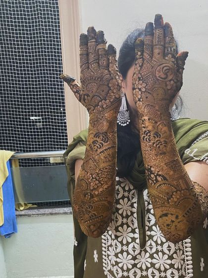 A playful pose showing off the full extent of this gorgeous bridal henna.