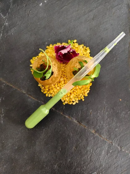 Who says you can't teach a classic new tricks? Our Thai Gol Gappe infuses the beloved Indian street food with fragrant Thai green curry flavors, served with a pipette for a fun, interactive, and unforgettable flavor explosion.