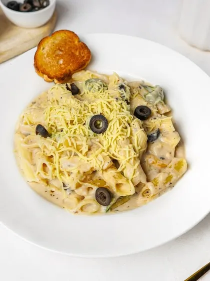 Another angle of the white sauce penne pasta, showing the creamy texture and fresh ingredients. Multiple angles like this are useful for creating a complete menu gallery.
