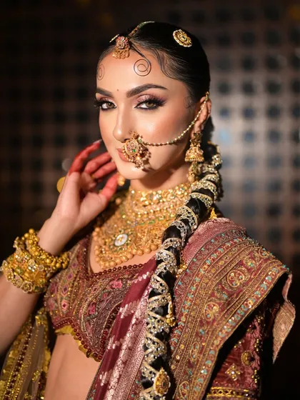 A side profile showcasing the intricately decorated traditional braid, a true work of art that completes this royal bridal look.