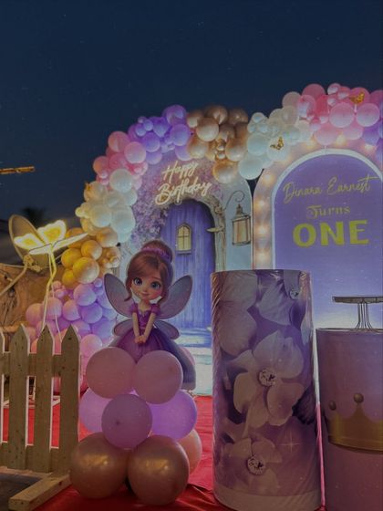 Here's a wider view of the royal princess first birthday setup on a terrace. We included a red carpet entrance, a picket fence, and custom plinths to complete the grand look.