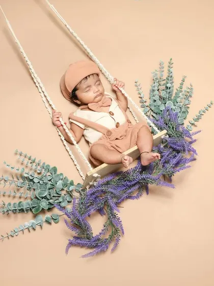 This little guy is dreaming away on a swing decorated with lavender. The soft colors and floral accents create such a calming scene.