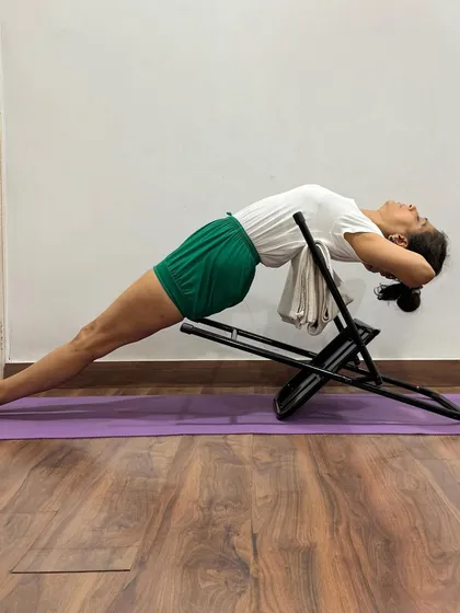 This variation of Purvottanasana uses an inverted chair to support the upper back. It creates a strong, stable base that allows the practitioner to work on lifting the pelvis and extending the spine.